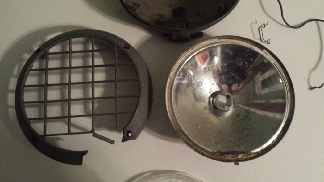 Fog lamp #1 has a broken front and back bezel. The lens is intact and the reflector is in better condition than the other 3.